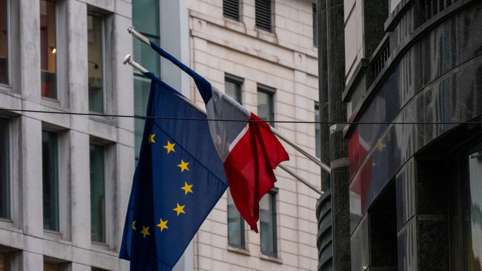 European Union and Polish flags outside a building in Brussels